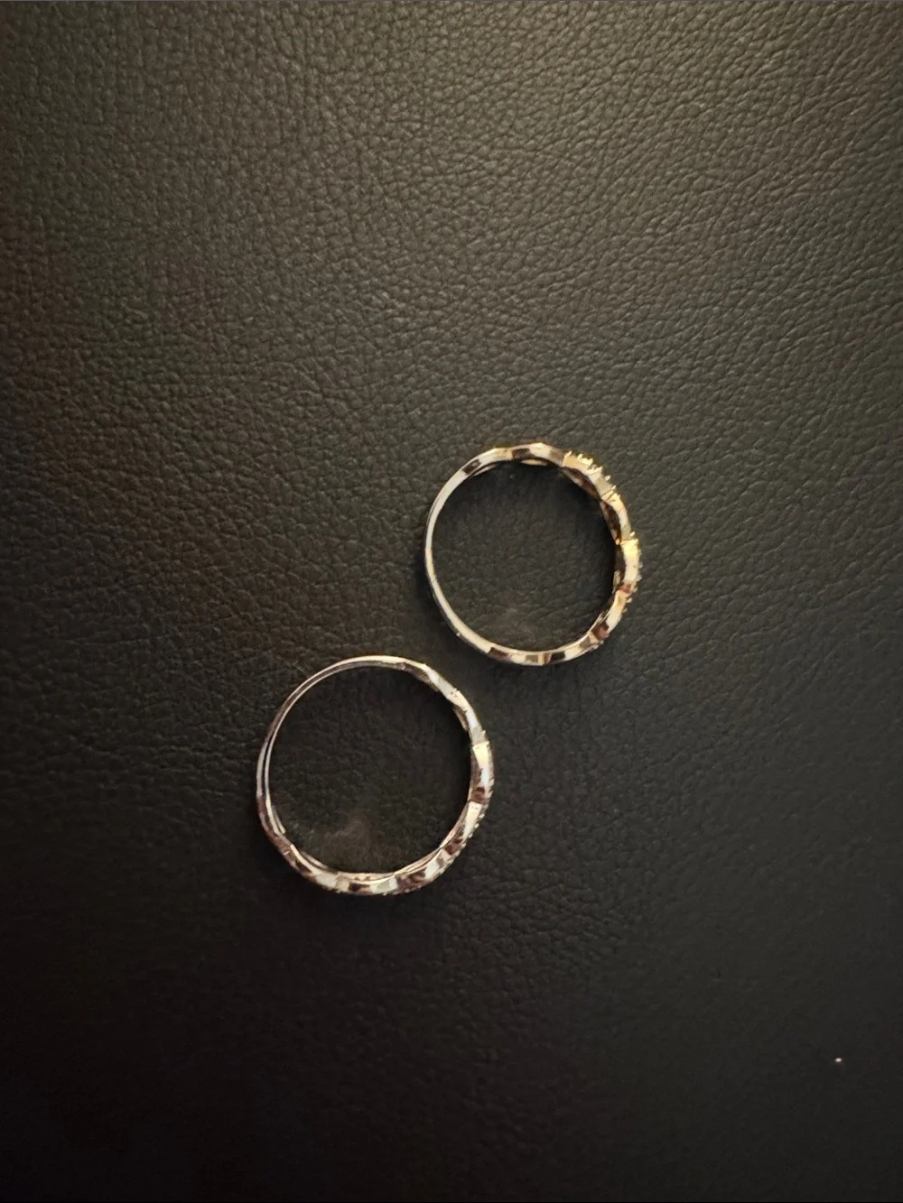 Size unknown: Silver and gold toned infinity rings- 2 rings